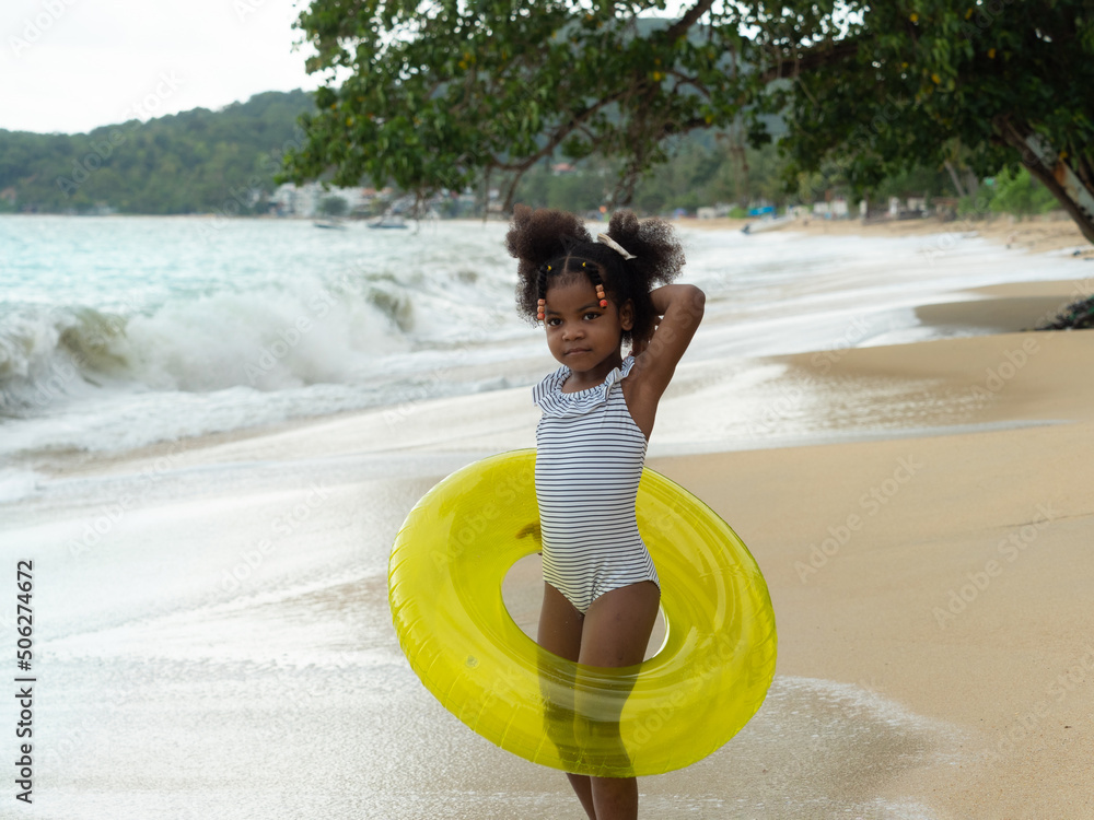 Cute little African girl wearing blue striped swimming suit with yellow Sexy Black Girls In Bikinis